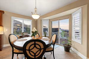 Dining room featuring light tile patterned flooring and baseboards