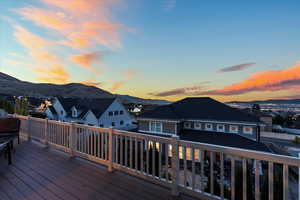 Deck at dusk with a residential view and a mountain view