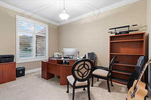 Home office featuring ornamental molding, light carpet, and baseboards