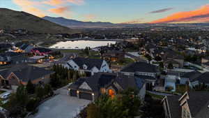 Aerial view at dusk featuring a residential view and a water and mountain view