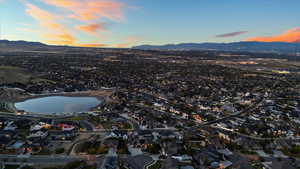 Aerial view at dusk featuring a residential view and a water and mountain view