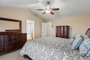 Bedroom with light carpet, lofted ceiling, and a ceiling fan