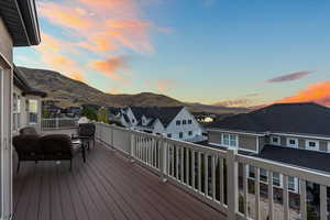 Wooden deck featuring a residential view and a mountain view