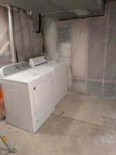 Washroom with laundry area and washing machine and clothes dryer