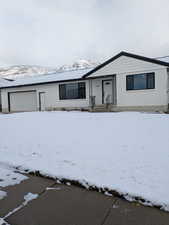 View of front of property with brick siding and a mountain view