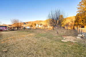 View of yard with fence and a mountain view