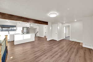 Kitchen featuring light wood-style flooring, a sink, visible vents, and stainless steel fridge with ice dispenser