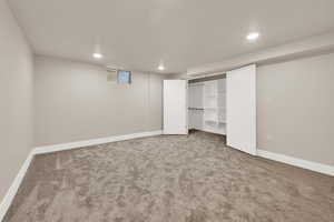 Unfurnished bedroom featuring carpet floors, baseboards, and recessed lighting