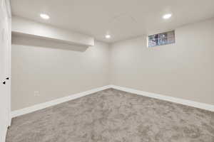 Finished basement with carpet floors, recessed lighting, and baseboards