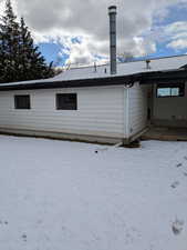 View of snow covered rear of property