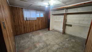 Below grade area with concrete block wall and wooden walls