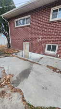 View of back of property with basement entrance