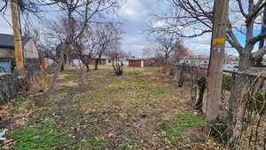 View of yard featuring fence and a residential view