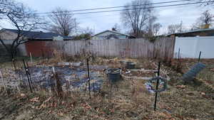 View of yard with a garden and a fenced backyard