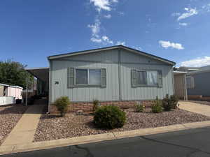 Manufactured / mobile home featuring a carport, crawl space, and driveway