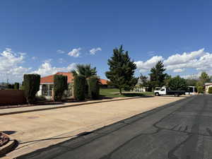 View of front of house featuring uncovered parking and fence