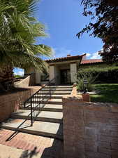 View of front of property featuring a tile roof and stucco siding