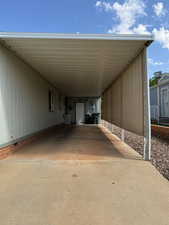 View of car parking with driveway and an attached carport