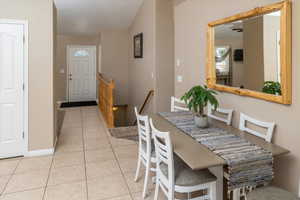 Dining area with baseboards and light tile patterned flooring