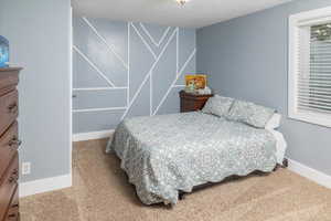 Carpeted bedroom featuring baseboards