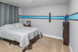 Carpeted bedroom with baseboards