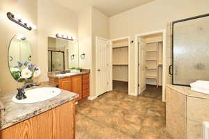 Primary Bathroom Featuring His/Her Closets, Double Vanity and Make-up Counter