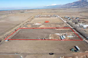 Drone / aerial view featuring view of desert, a rural view, and a mountain view