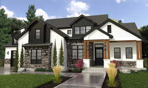 View of front of house with metal roof, stone siding, a shingled roof, and a standing seam roof