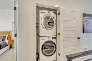 Laundry room with stacked washing maching and dryer