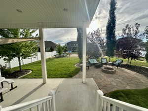 View of patio featuring fence private yard and a fire pit