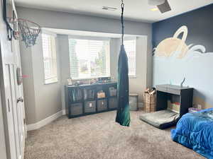 Carpeted bedroom with baseboards, visible vents, and a textured ceiling