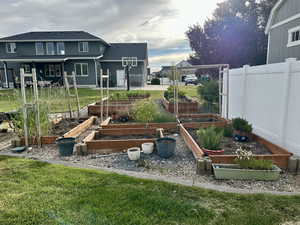 View of yard with a garden and fence