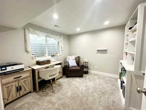 Home office with recessed lighting, light colored carpet, visible vents, and baseboards