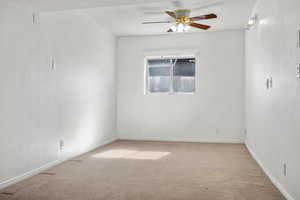 Empty room with light carpet, ceiling fan, and baseboards