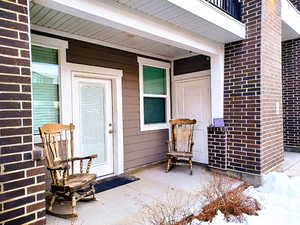 Entrance to property featuring brick siding