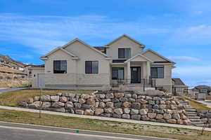 View of front facade featuring stucco siding