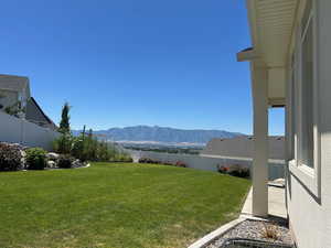 Fenced backyard with a mountain view