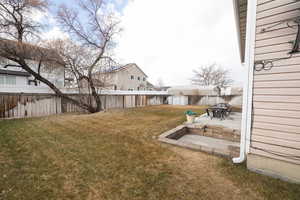 View of yard with a storage unit and a patio