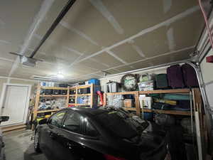 Garage featuring a garage door opener and a workshop area