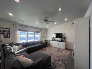 Living room featuring light colored carpet, visible vents, vaulted ceiling, and recessed lighting