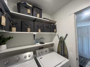 Laundry room with laundry area and washer and clothes dryer