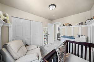 Bedroom featuring marble finish floor and a closet