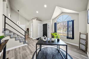 Home office featuring high vaulted ceiling, light wood finished floors, recessed lighting, and baseboards