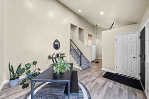 Entrance foyer with stairs, recessed lighting, light wood-type flooring, and baseboards