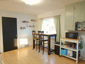 Dining space with light wood-style floors and visible vents