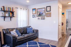 Large Living area with recessed lighting, baseboards, and wood finished floors