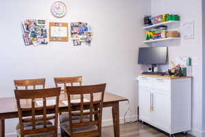 Dining area with dark wood finished floors