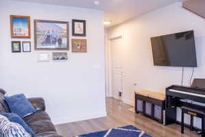 Living area featuring light wood-type flooring and baseboards