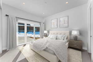Carpeted bedroom featuring access to exterior and recessed lighting