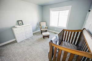 Carpeted bedroom featuring visible vents and baseboards